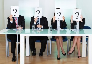 Row of businesspeople with question marks