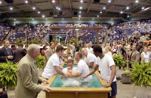 00a0xbaptism2.cut JESSE OSBOURNE / Courier & Press About 50 people were baptized as Jehovah's Witnesses Saturday afternoon at Roberts Municipal Stadium. Candidates lined up to be dunked one-by-one while attendants with mops stood nearby to clean up any spills. The baptism was part of the annual Jehovah's Witness district convention, which drew around 5,000 people from all over the region.